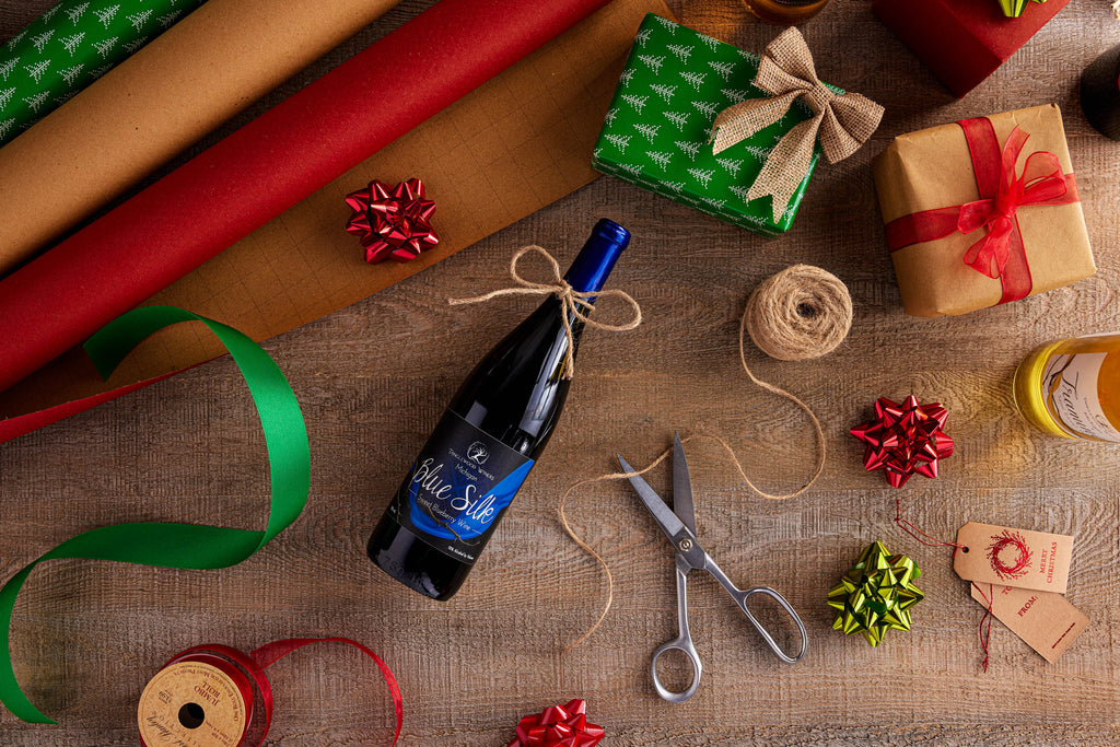 A bottle of Tanglewood's Blue Silk Wine is wrapped and ready for Christmas along with other presents.